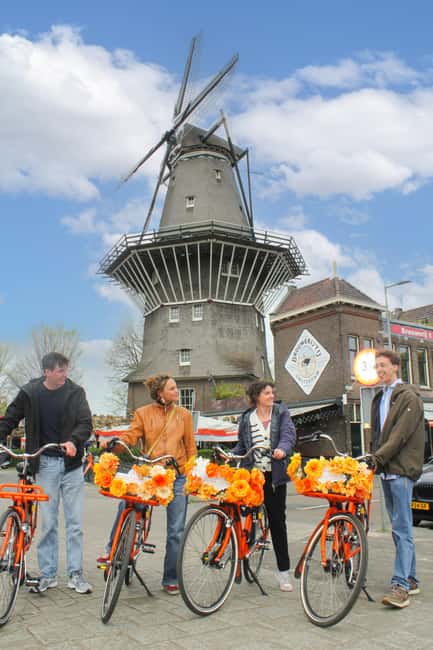 Amsterdam: E-Bike, Cheese, Windmill & Countryside Tour - Leaving Central Amsterdam by ferry and bike