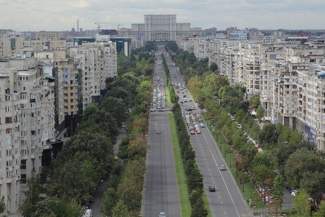 Bucharest Half a Day Bike Tour - The Palace of Parliament explains the communist scale