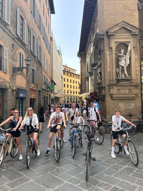 Florence: Untold Small Group Bike Tour - Piazza della Signoria, wine windows, and Medici power