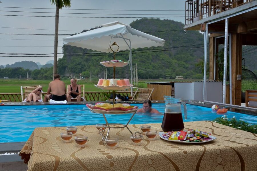 Ninh Binh Daily: Hoa Lu, Mua Cave, Tam Coc, Bike & Swimming - Sunset tea, fruit, and swimming