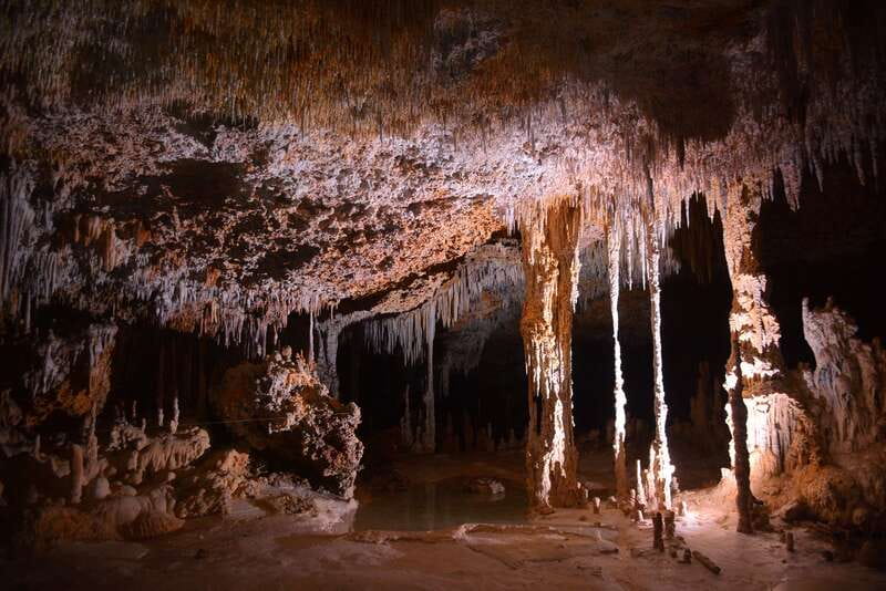 Rio Secreto Nature Reserve: Bicycle, Rappel & Ziplines Tour - Entering the cave beside the underground river